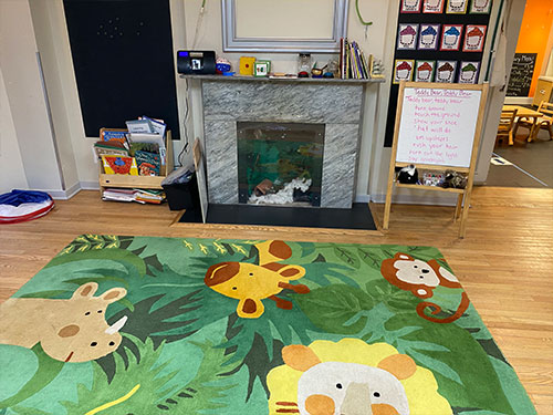 Photo of Urban Child Academy's Gold Coast Two's Room with carpet area and mantle