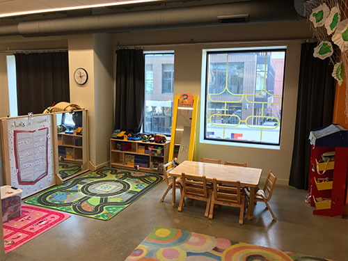 Photo of Urban Child Academy's River North Two's Room with child's chairs and cubbies